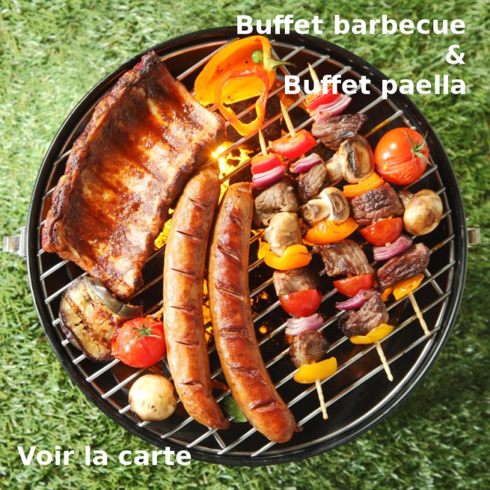 Tasty assortment of meat on a summer barbecue with sausages, beef kebabs and spare ribs with tomatoes and mushrooms, overhead view over green grass
